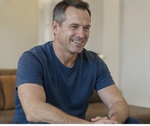 Man feeling calmer after understanding urinary symptom triggers