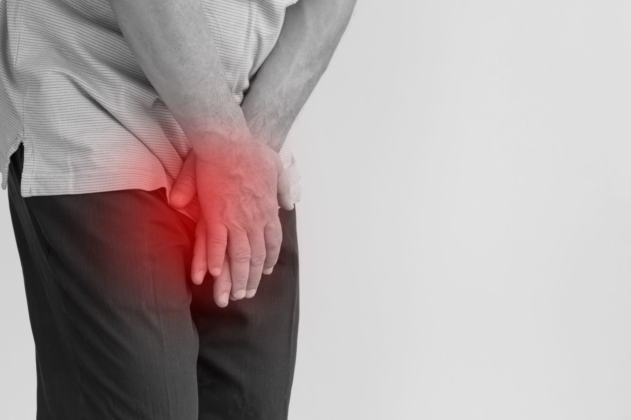 Man experiencing pelvic discomfort, a common symptom men may notice with prostatitis