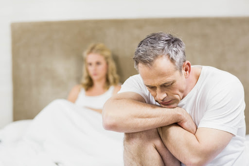Man sitting apart from his partner, representing how prostatitis symptoms can affect confidence and relationships